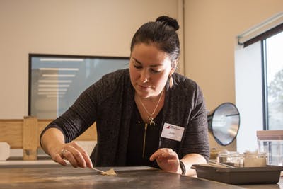 Julie Ribits works on restoring a painting Nov. 4 during a tour of the Eskenazi Museum of Art. Ribits is the painting conservator for the museum and plans to examine every piece of art in the museum to learn their stories.