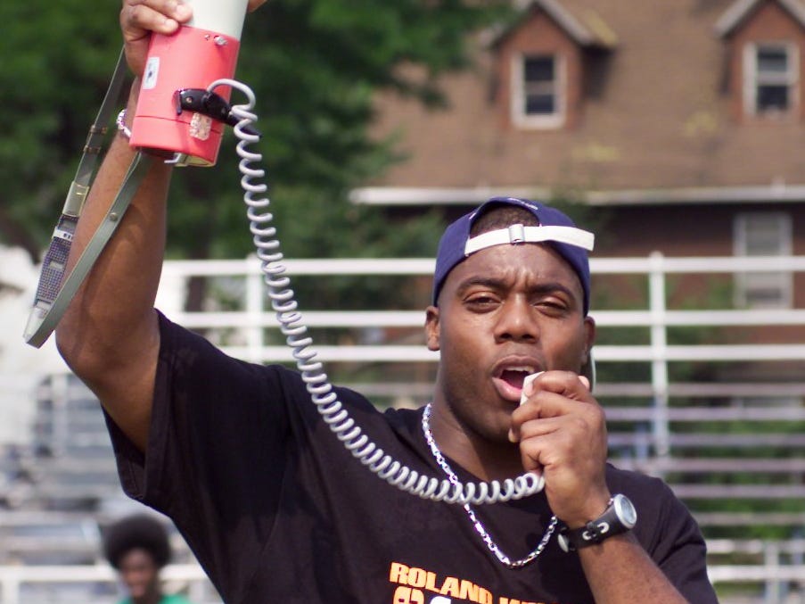 Retired tight end, and Rochester native Roland Williams calls out commands using a megaphone during the opening session of his Roland Williams Free Football Camp Friday, June 29, 2001 at East High School in Rochester. The three day camp features NFL players and coaches instructing nearly 200 kids.