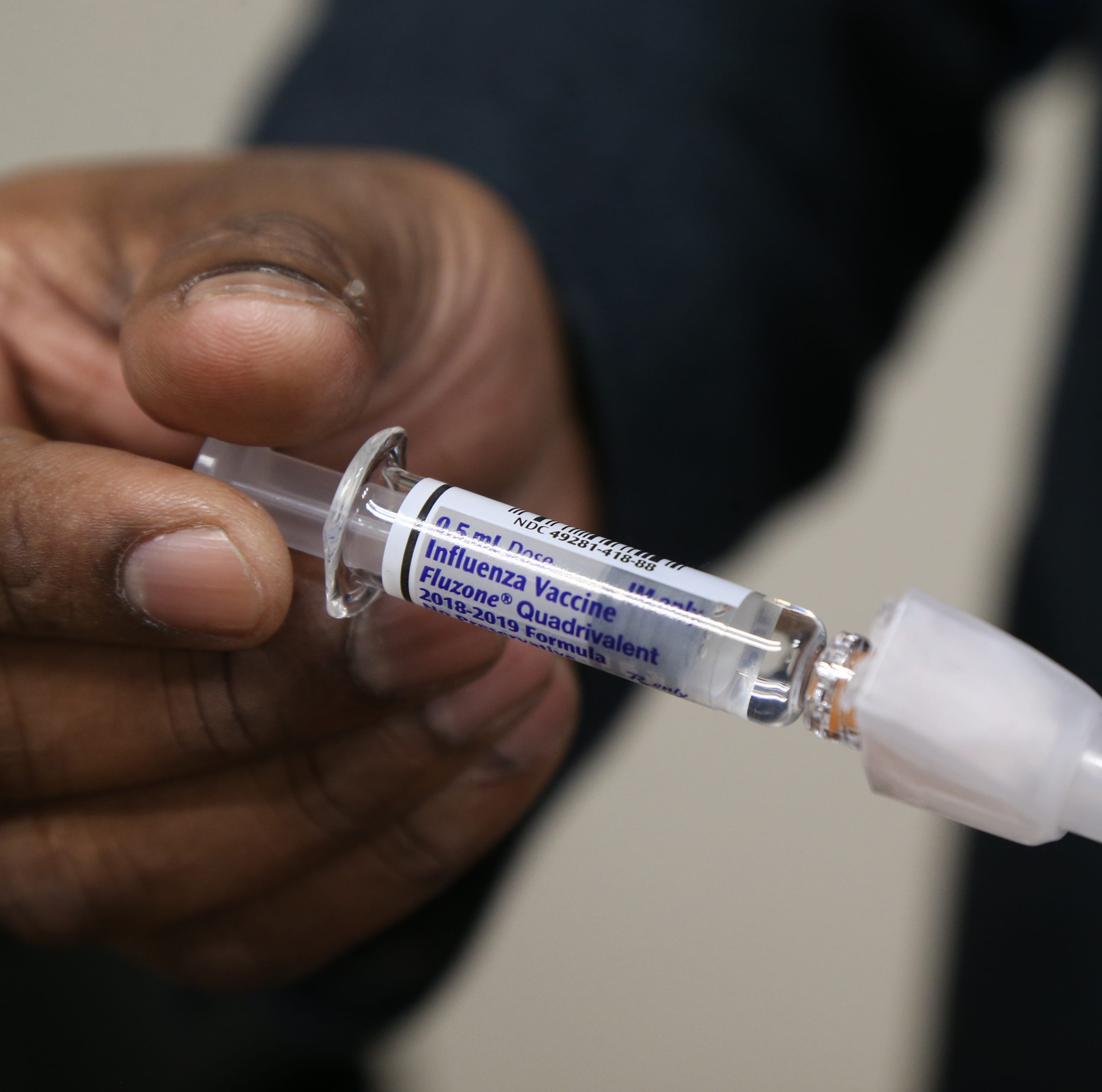 Dr. Anil Vaidian, commissioner of Behavioral and Community Health, holds a syringe with the flu vaccine at the Dutchess County Department of Behavioral and Community Health in the City of Poughkeepsie on December 27, 2018. 