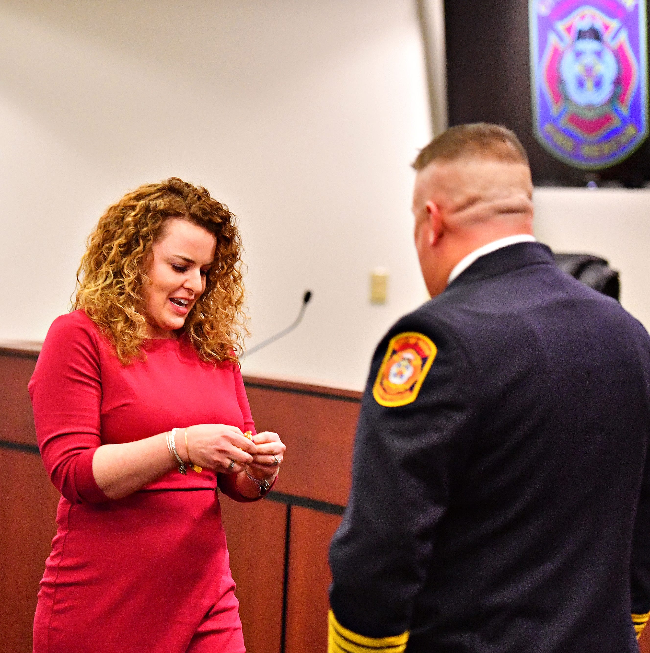 Jess Deardorff, left, prepares to pin her husband, York City Fire Chief Chad Deardorff during his swearing-in ceremony at York City Hall in York City, Friday, March 8, 2019. Dawn J. Sagert photo