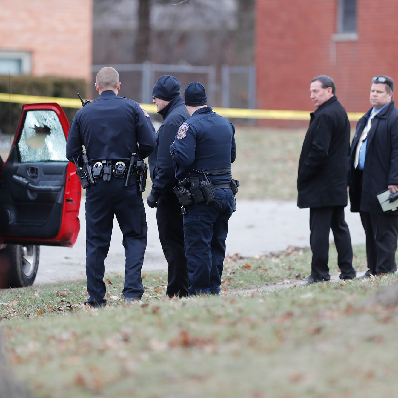 IMPD investigators are on the scene of a double homicide in the 4500 blocks of N. Irwin Ave. in Indianapolis, Thursday, Jan. 9, 2020. A red SUV containing the victims was blocked off by crime scene tape. 