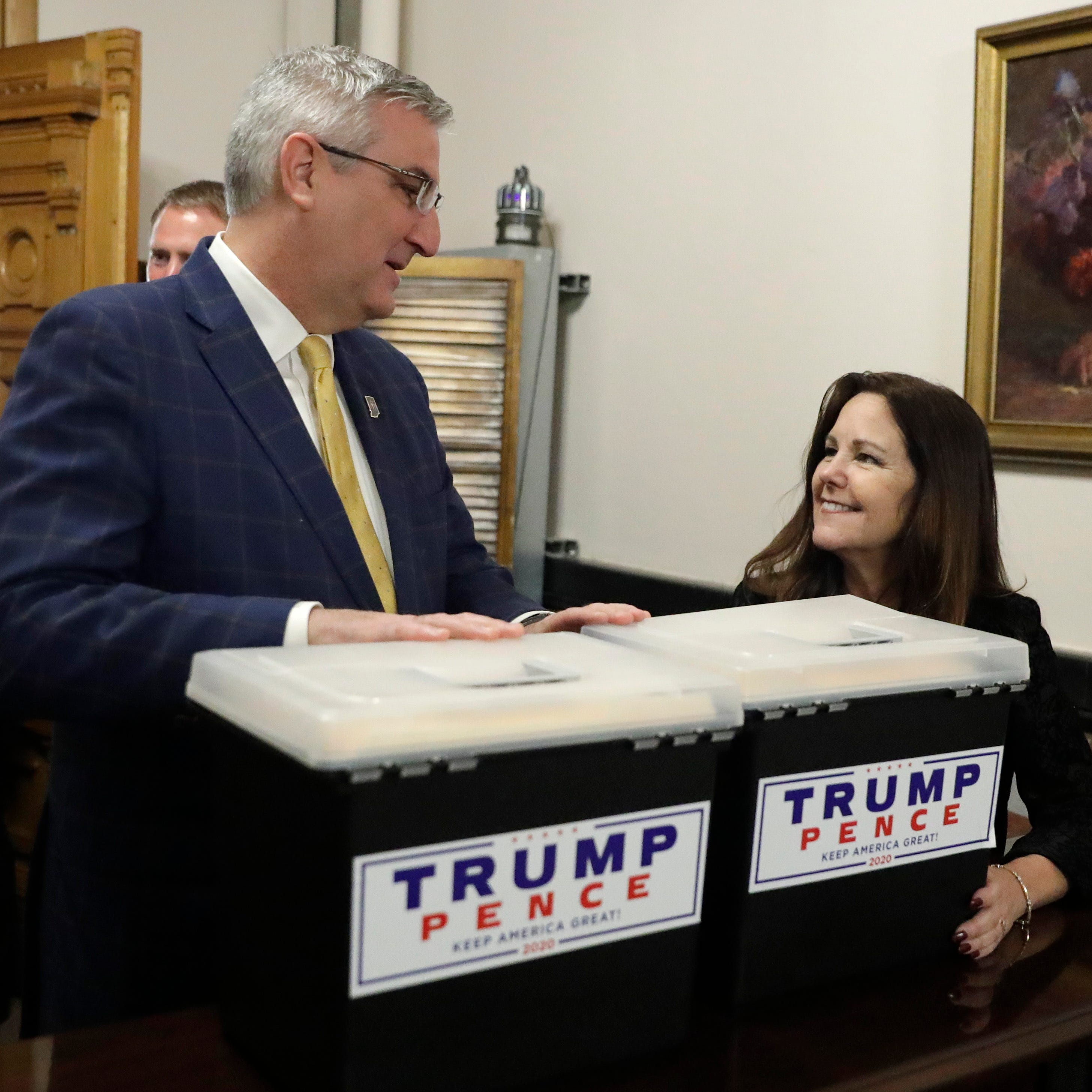 Second lady Karen Pence speaks with Indiana Gov. Eric Holcomb at the Statehouse after delivering paperwork putting President Donald Trump's name on the Indiana primary ballot, Wednesday, Feb. 5, 2020, in Indianapolis. (AP Photo/Darron Cummings)