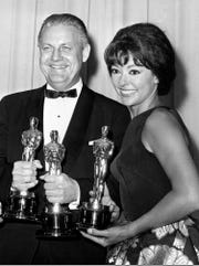 In this April 9, 1962 file photo, Oscar winners for "West Side Story," Robert Wise and actress Rita Moreno, pose at the Academy Awards in Santa Monica, Calif.