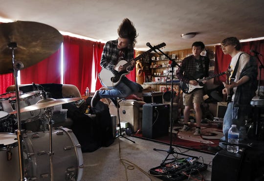 Henry Byrne 17 of Hillard wraps up a song with bandmates , Jack Lutz 17 of Heath, Alex Brannon 18 of Newark, who along with drummer Jaxson Tackett, 16, form the band Aura. The band will be competing in the Rock and Roll Hall of Fame in Cleveland as part of a battle of the bands competition. They were rehearsing at Jack's home on Feb. 2, 2020.