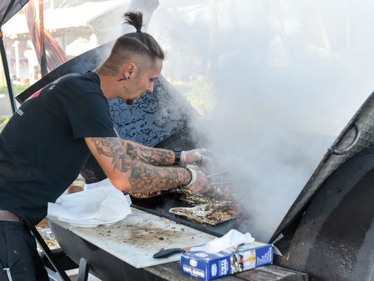 Cory Lach of Simply Southern Catering Co. checks on his mouth watering chicken and pork during the Bonita Blues Festival held at Riverside Park in Bonita Springs, Friday March 9.