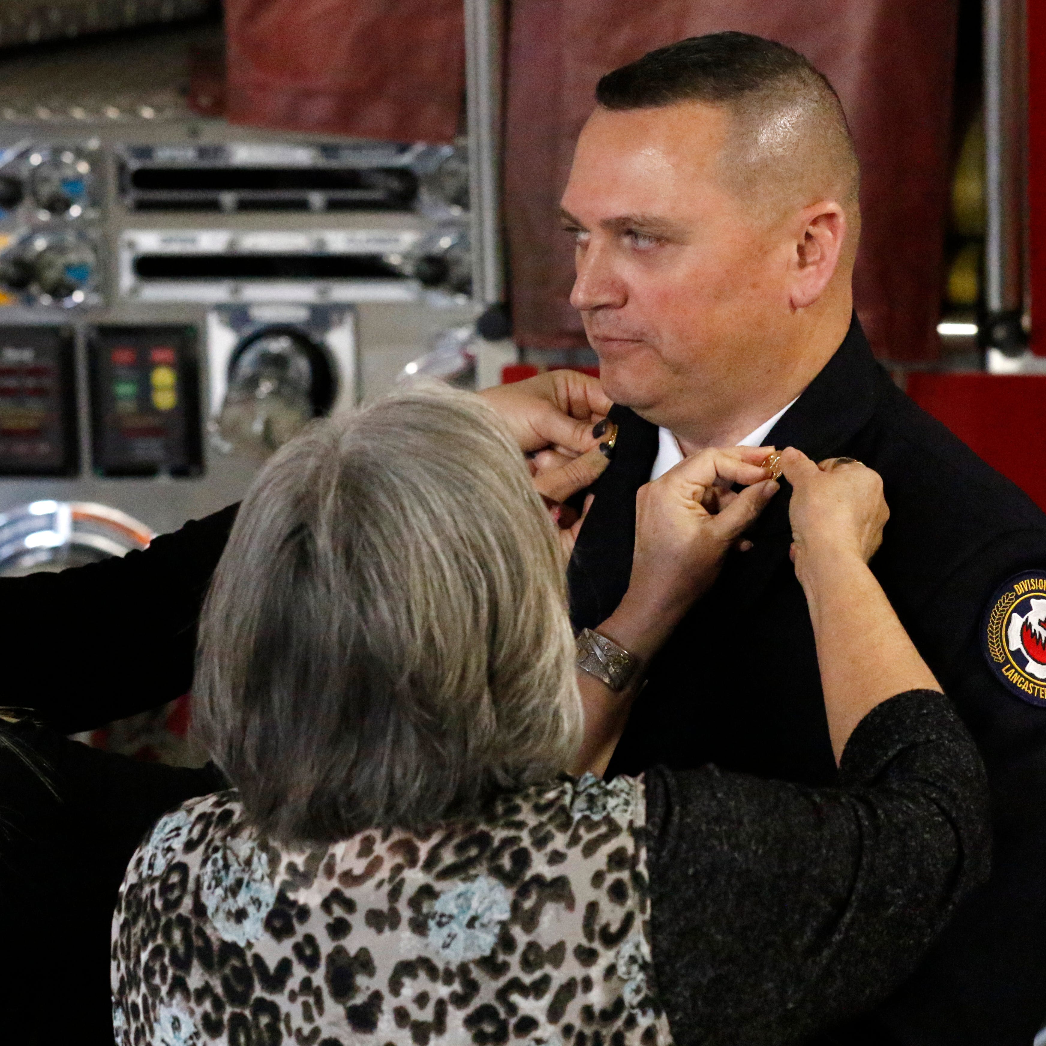 Lancaster Fire Department Assistant Chief K.J. Watts, shown during his at his swearing-in ceremony for his current position last year, recently recovered from the coronavirus. He was sick for about two weeks and said the illness feels 10 times worse than the flu.