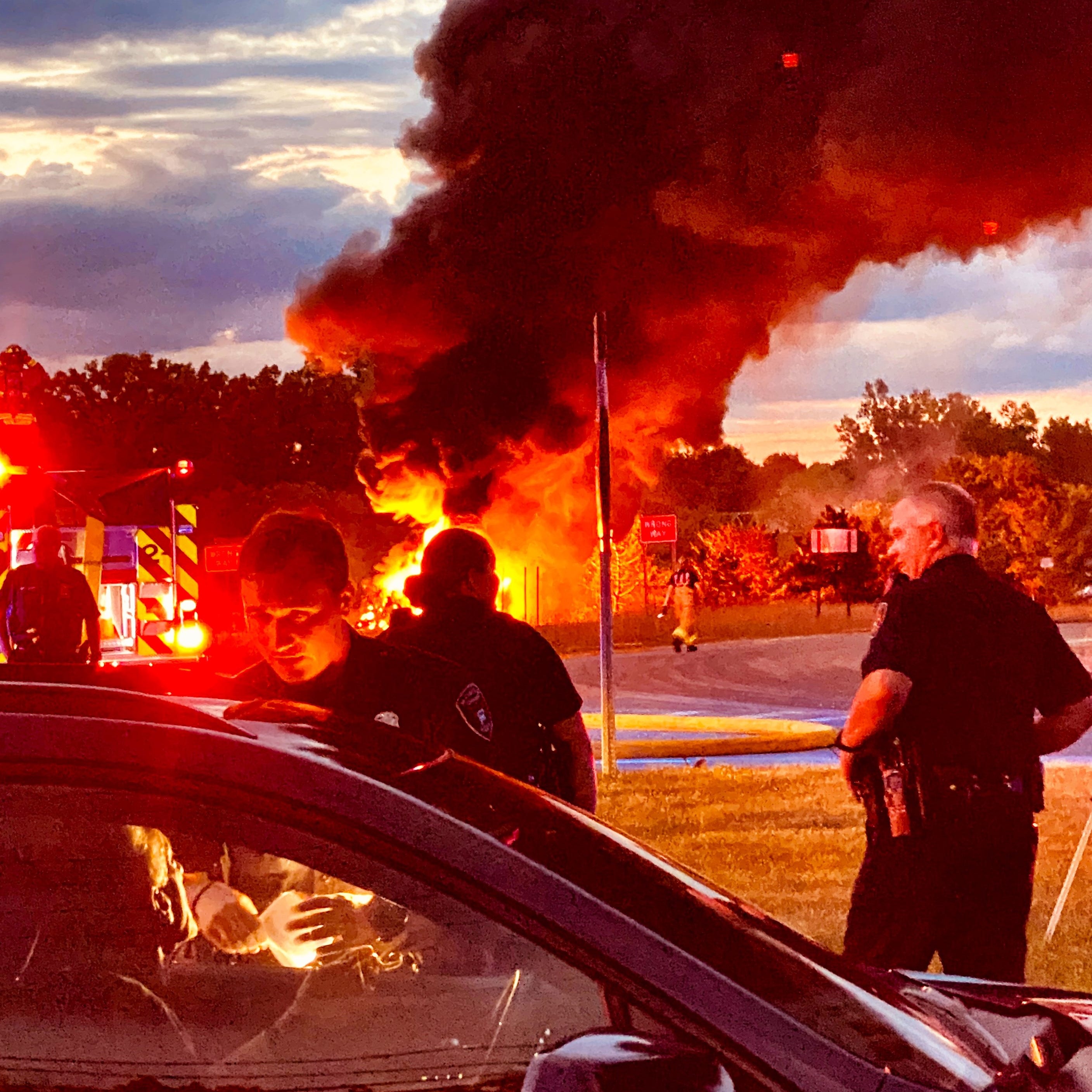 At the scene of the tanker crash and fire, a driver is stopped and questioned by Bloomfield Township police.