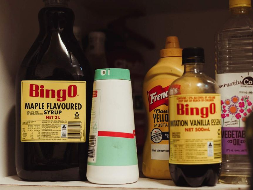 Bottles of Bingo Maple Syrup, French's American mustard and Bingo vanilla essence sit on a low shelf.