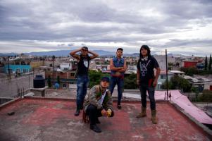 a group of people posing for the camera: Members of Mexican rock band Los Cogelones, the Sandoval brothers (L-R) Beto, Victor, Gabriel and Marco pose for a photograph in Ciudad Nezahualcoyotl on August 12, 2020