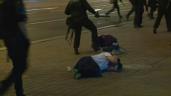 a group of people walking on a sidewalk: Second night of protests in Belarus after contested presidential vote