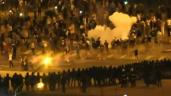 a group of people standing in front of a crowd: Police, protesters clash in Belarus capital after vote