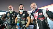 a group of people posing for the camera: Around 60 members of the "Hawks" Harley Davidson Club gather in Dubai to help volunteers of the Emirates Red Crescent pack and load humanitarian aid worth 1 million dirhams (around $272,000 dollars) for Beirut's blast victims.