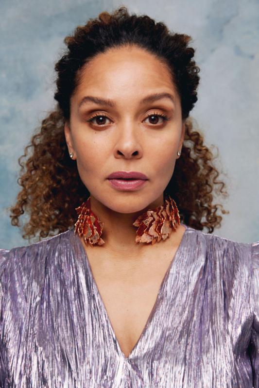 Woman wearing purple and facing forward. 