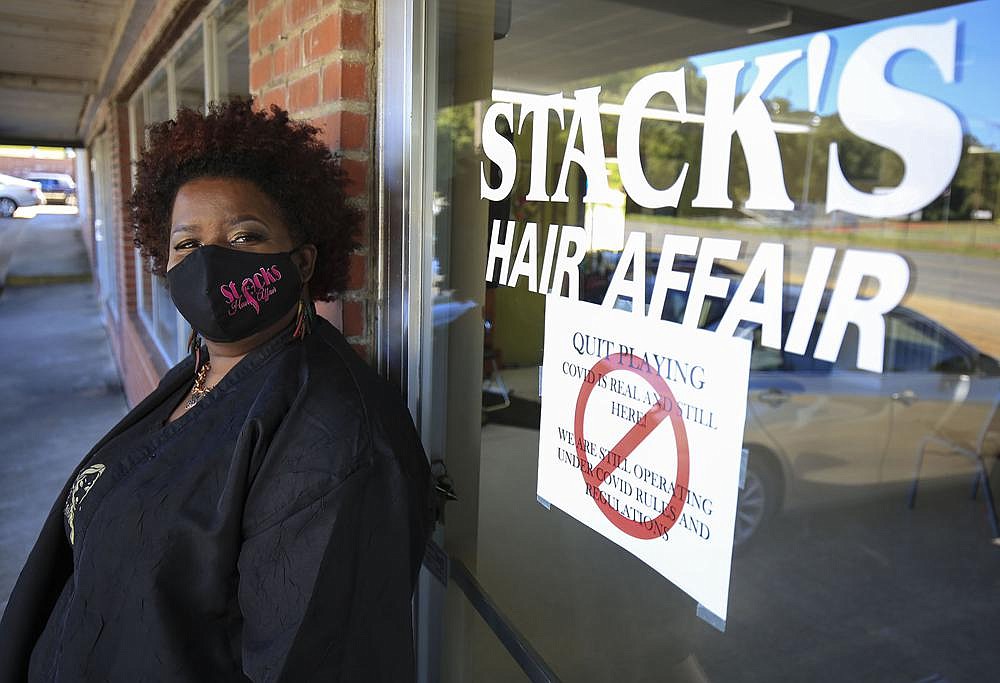 Detria Stackhouse, owner of Stack’s Hair Affair, says her shop is open, but most of her customers can no longer afford the services. More photos at arkansasonline.com/104delta/. (Arkansas Democrat-Gazette/Staton Breidenthal)